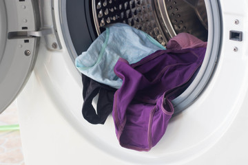 Washing machine full of dirty clothes.
