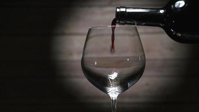 Pouring red wine into glass