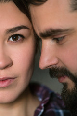 Close portrait of a young couple. Man and woman in love. Cling to each other.