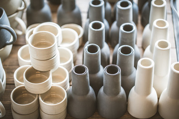 Rustic handmade ceramic clay white cups souvenirs on the Street handicraft market.