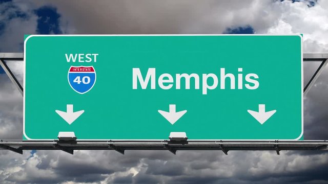 Memphis Tennessee interstate route 40 overhead freeway directional arrow sign with time lapse clouds.