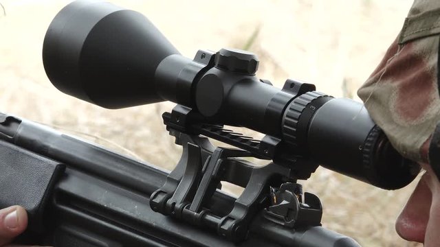 Detail sniper aims target and reload gun