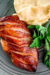 Fried chicken fillet, mashed potatoes and sauce in a gray plate on a wooden board in a rustic composition. national Ukrainian and Russian dish. close up. flat lay 