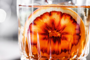 cocktail with sicilian orange in a glass close-up. Sicilian orange slice close up