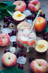 Cocktail with organic fresh peaches and cherries