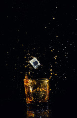 Isolated shot of whiskey with splash on black background