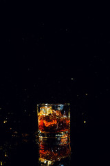 Isolated shot of whiskey with splash on black background