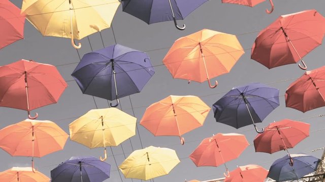 Colorful umbrellas hanging in the sky. Holiday, fest, joy concept.