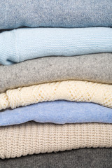 Fototapeta na wymiar Winter and fall cozy sweaters stack, woolen sweaters