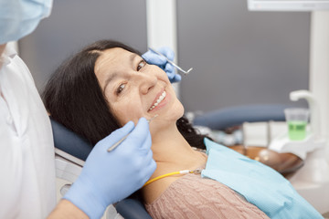 Healthy teeth. Beautiful senior woman smiling to the camera while on a dentist checkup at the clinic medical healthcare examination teeth toothy smile happiness dentistry health retirement concept