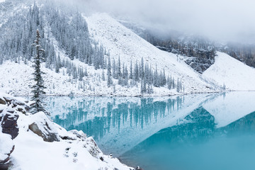 First snow Morning at Moraine Lake in Banff National Park Alberta Canada Snow-covered winter mountain lake in a winter atmosphere. Beautiful background photo