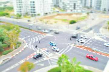 High angle view of road intersection and crosswalk with traffic in the city of Tel Aviv, Israel. Crossing roads and car concept.  