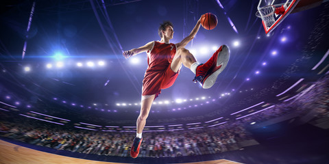 Basketball player in jump. around Arena with blue light spot