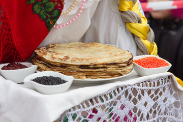 Pancakes with red caviar and black caviar. Traditional Russian food for the holiday "MASLENITSA". Russia winter holiday.