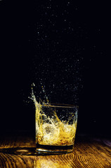 Isolated shot of whiskey on wooden background