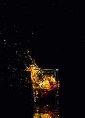 Isolated shot of whiskey with splash on black background