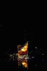 Isolated shot of whiskey with splash on black background