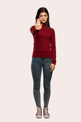 A full-length shot of a Teenager girl with turtleneck making stop gesture denying a situation that...