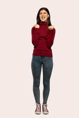A full-length shot of a Teenager girl with turtleneck frustrated by a bad situation over isolated background