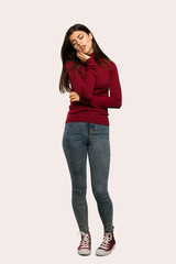 A full-length shot of a Teenager girl with turtleneck with toothache over isolated background