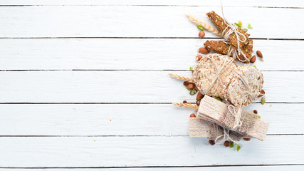 Oatmeal bars, muesli, flax, healthy snacks. On a white wooden background. Top view. Free space for your text.