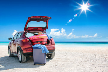 Red summer car on beach and free space for your decoration. 