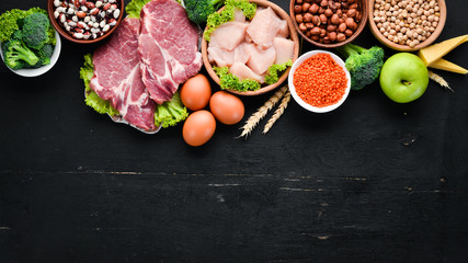 High protein food. Healthy nutrition or diet concept. Meat, chicken fillet, broccoli, beans,...