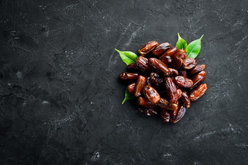 Dry date on a black background. Top view. Free space for your text.