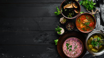 Ukrainian cuisine. Borsch soup with mushrooms, fish soup. Top view. Free space for your text. Rustic style.