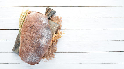 Fresh bread of dark flour. Top view. Free space for your text.