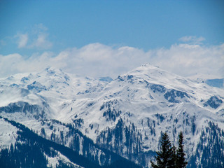 Obraz premium View of snowy austrian alps with old wooden hut, trees, sunny weather at wonderful blue sky