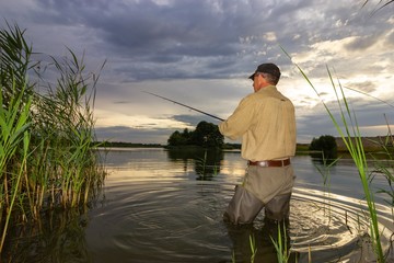 Angler catching the fish during an overcast day