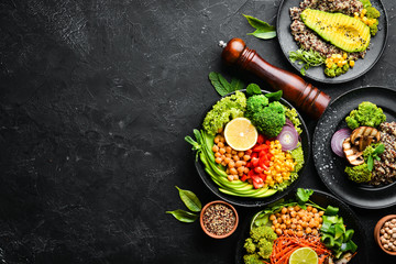A set of healthy food on a black stone table. Bowl Buddha. Top view. Free space for your text.