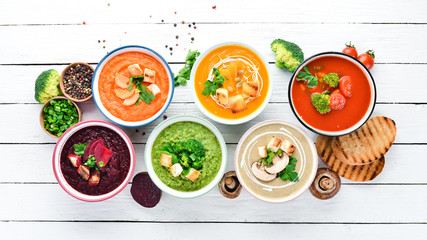 Variety of colorful vegetables cream soups. Concept of healthy eating or vegetarian food. Top view....