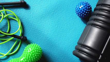 Massage ball and roller for self massage, reflexology and myofascial release, blue background....