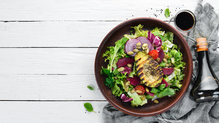 Salad. Lettuce, beets, avocados and pumpkin seeds. Top view. On a white wooden background. Free copy space.