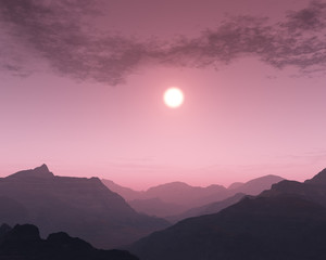 Foggy sunset over mountain landscape.