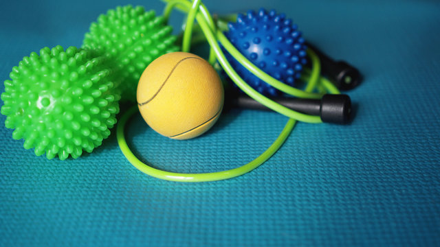 Massage ball and roller for self massage, reflexology and myofascial release, blue background. Equipment for sports, yoga, fitness © brillianata