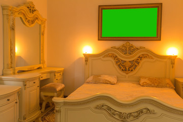 A bedroom with a large white bed and a small children's bed.