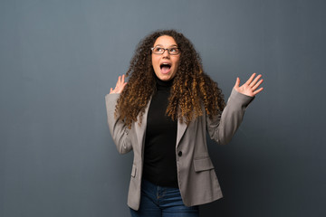 Teenager girl over dark wall