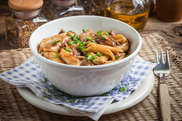Pasta penne with pork sauce.