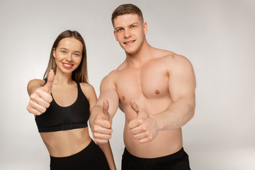Fototapeta na wymiar Athletic man with naked torso and beautiful woman after fitness exercises