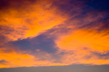 Landscape with dramatic light - beautiful golden sunset with saturated sky and clouds.