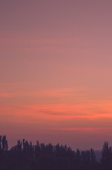 Landscape with dramatic light - beautiful golden sunset with saturated sky and clouds.