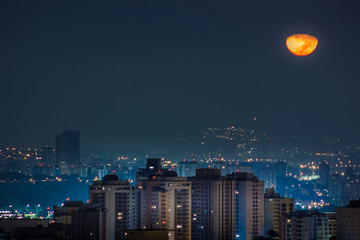 city at night with moon and stars