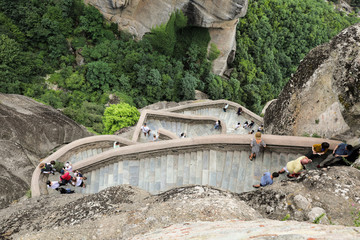Meteora, Greece - 31 July, 2018: Tourists on the stairs of the Monastery of Varlaam from Meteora Eastern Orthodox monasteries complex in Kalabaka, Trikala, Thessaly, Greece.