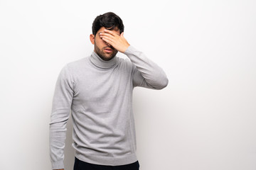 Young man over isolated white wall covering eyes by hands. Do not want to see something