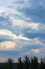 Landscape with dramatic light - beautiful golden sunset with saturated sky and clouds.