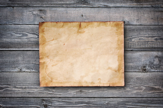 Gray wooden background with mockup of vintage yellowed paper card