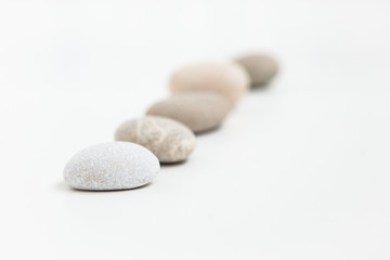 Pebbles in a row on the white ground